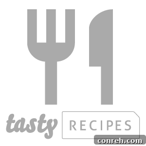 Ground Beef Red Enchiladas served in a baking dish, topped with melted cheese and fresh cilantro.