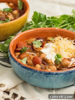 Hearty Mushroom Chipotle Chili in a bowl with toppings