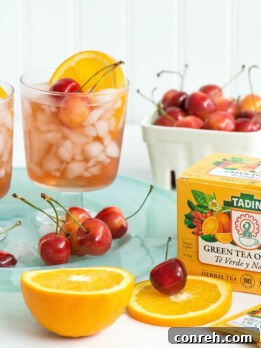 Orange Cherry Smash Iced Tea in a glass with garnishes
