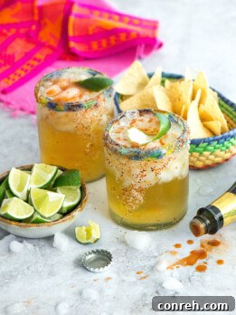 Picante Picante, a tequila-infused michelada cocktail with a chili-salted rim and lime garnish