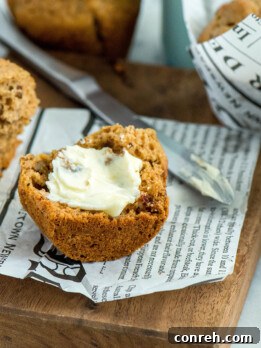 A freshly baked Chai Spice Muffin with dates and pecans, ready to be enjoyed.