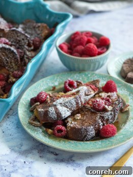 Delicious Mexican Chocolate French Toast with raspberries and pecans, ready to be served for brunch.
