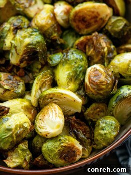 Beautifully roasted Brussels sprouts on a baking sheet, ready to be served.