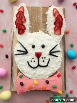 A delightful Easter Bunny Cake, decorated with coconut 'fur' and fruit details, perfect for spring celebrations.