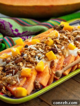 Vibrant Papaya and Mango Yogurt Salad with Granola, served on a beautiful platter