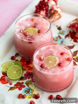Pomegranate Limeade in a glass with fresh fruit