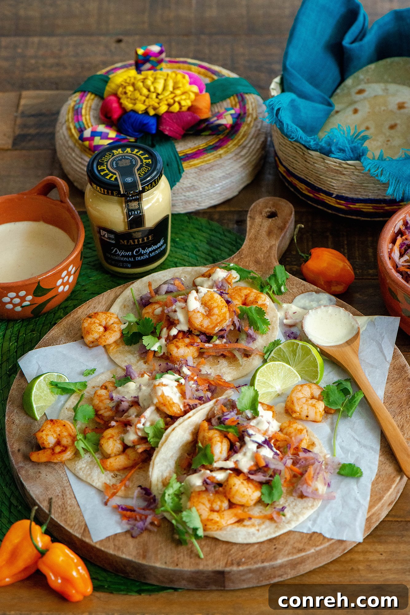 Delicious shrimp tacos served on a plate with vibrant garnishes.
