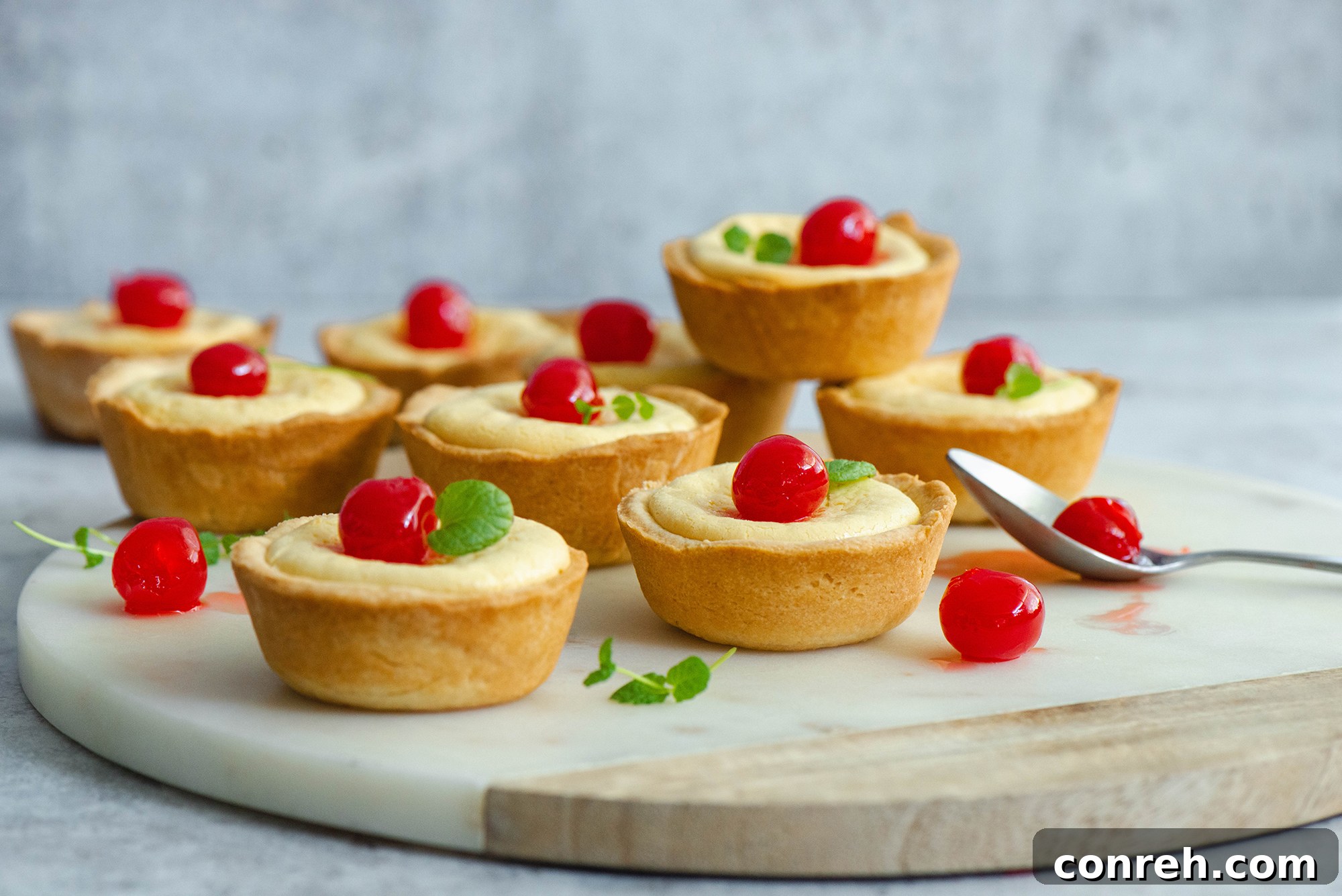 An overhead shot of several Cubiletes de Queso, some with cherries, arranged aesthetically.