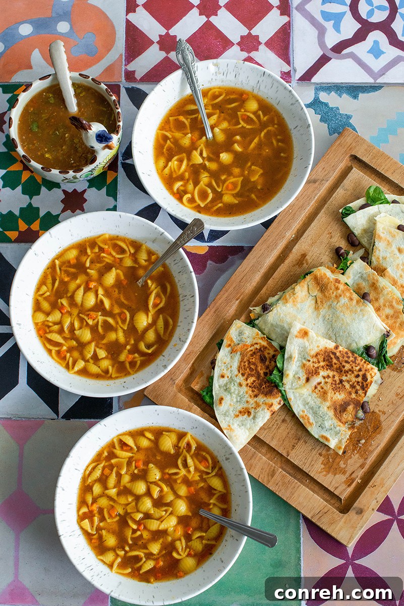 A person holding a bowl of Knorr Sopa Mexicana soup, with quesadillas in the background.