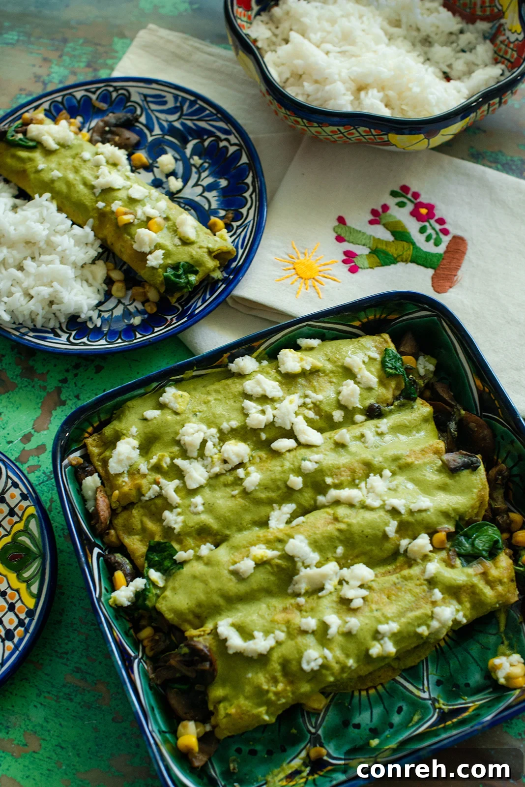 Puebla-Style Garden Enchiladas 2 Freshly prepared Vegetable Enchiladas Poblanas, showcasing the rich green sauce and crumbled queso fresco.