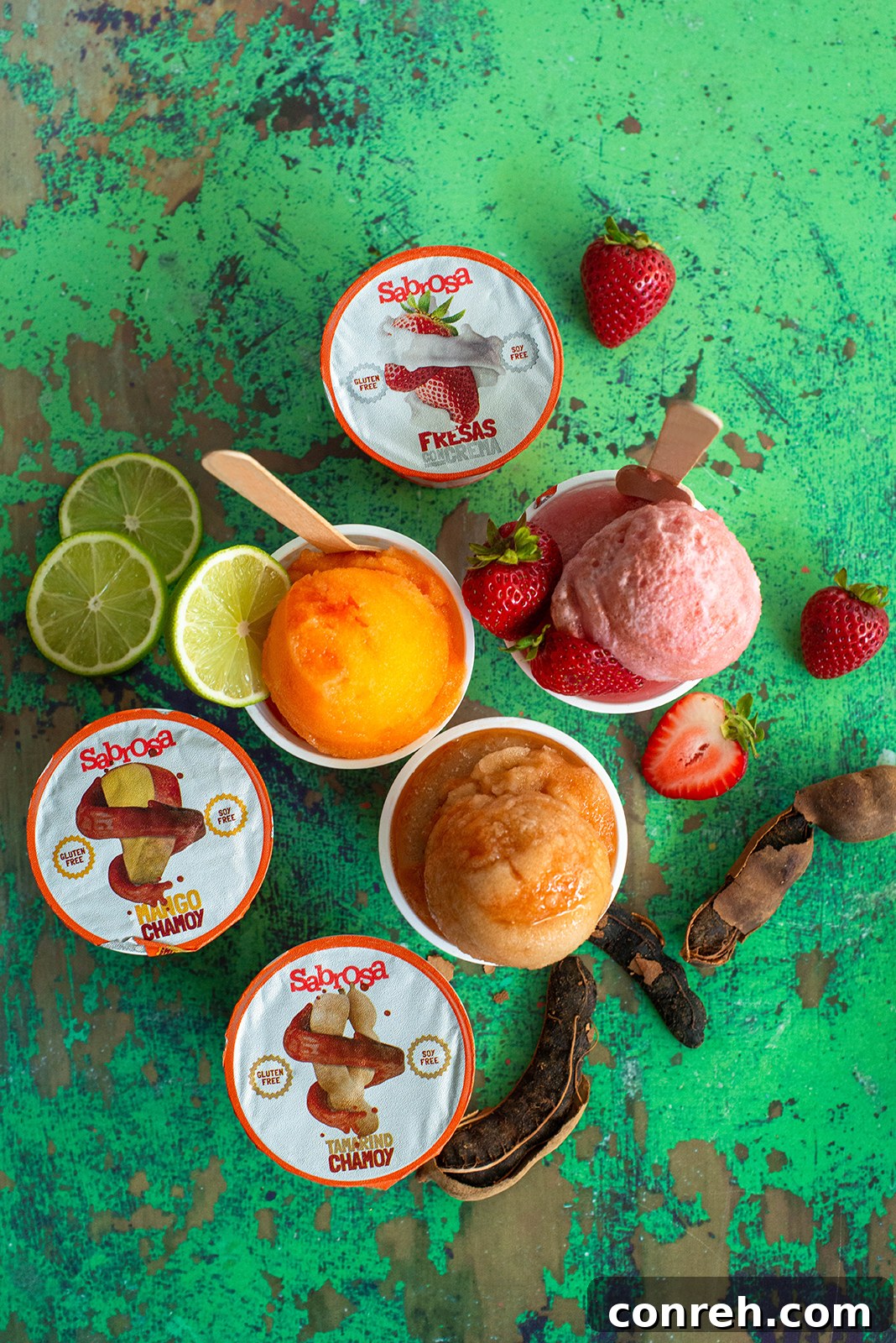 Flavorful Shaved Ice 4 Three cups of Sabrosa Raspado with spoons, ready to be enjoyed as a refreshing dessert.