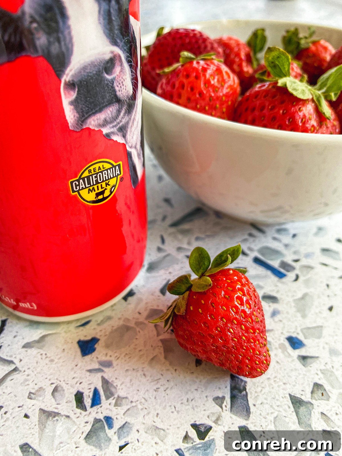 A stack of cereal french toast with syrup and berries