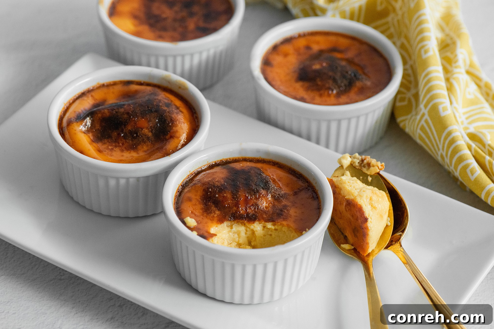 Guadalajara's Custard Delight 3 Close-up of three Jericallas in ramekins, with a golden brown top, ready to be served.