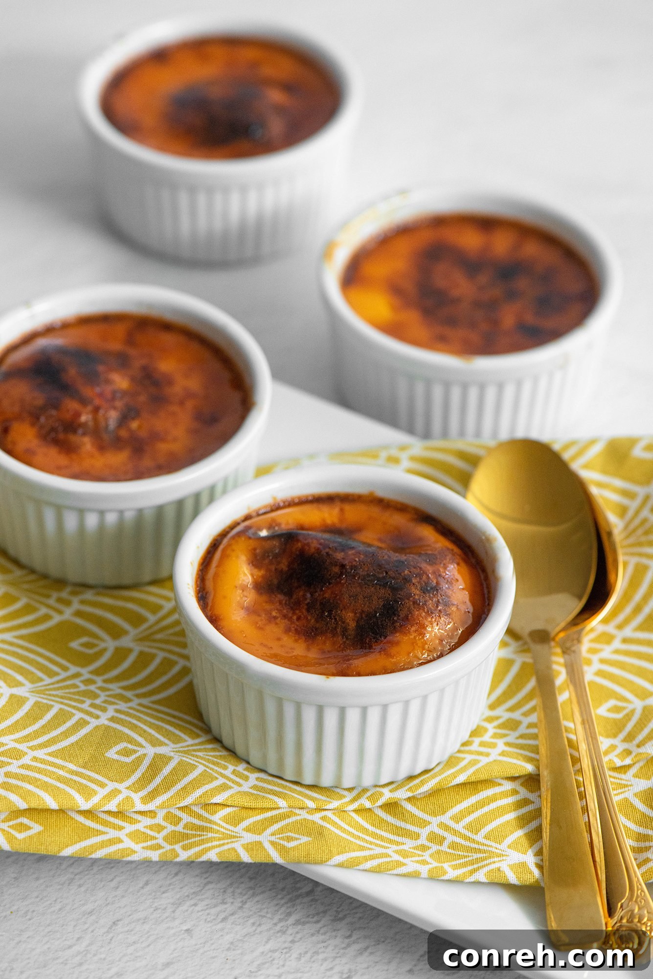 Guadalajara's Custard Delight 4 A top-down view of several Jericallas in a baking dish, showcasing their perfectly browned tops after broiling.