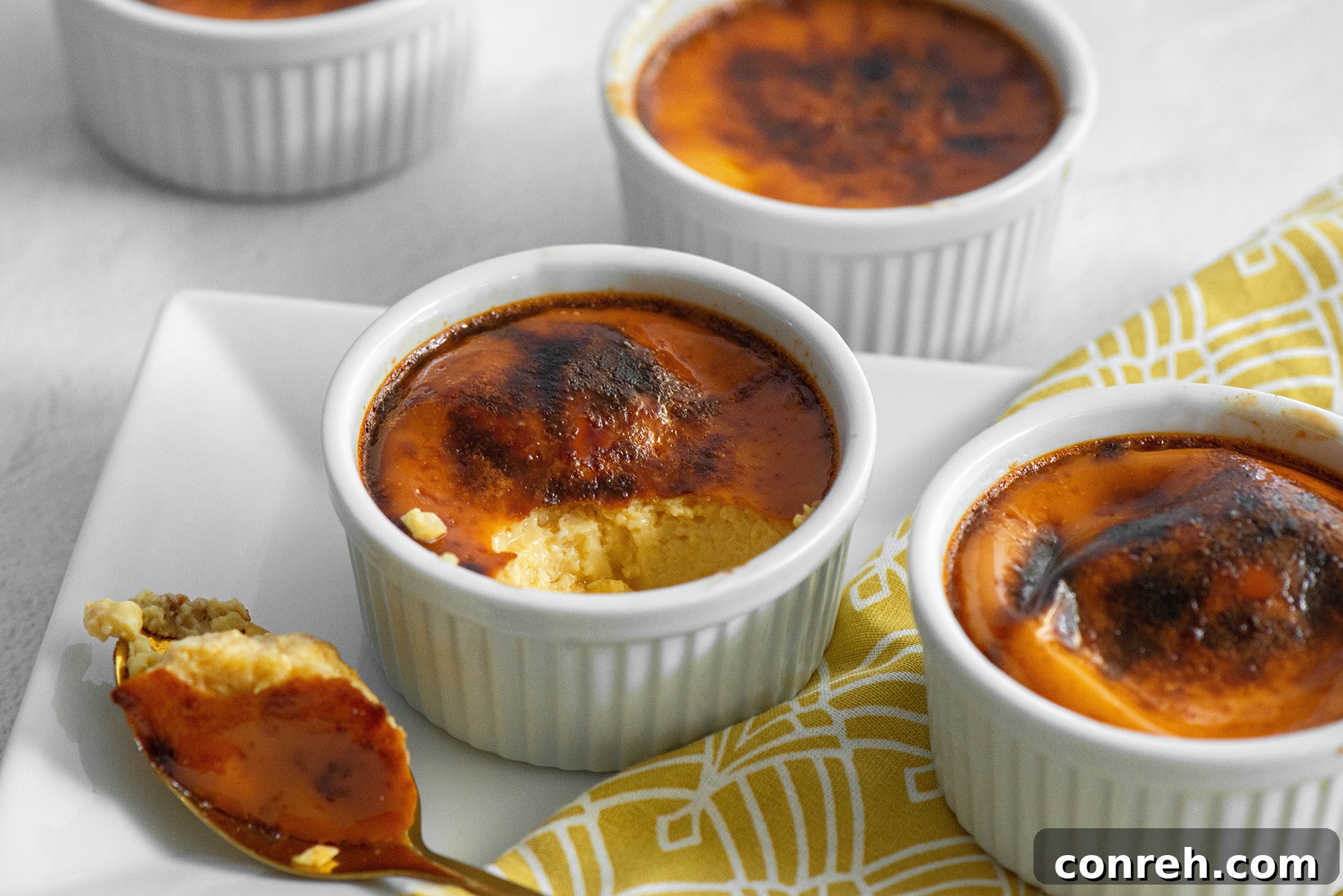 Guadalajara's Custard Delight 5 A close-up of a Jericalla with a spoon taking a bite, showing the creamy texture beneath the roasted top.