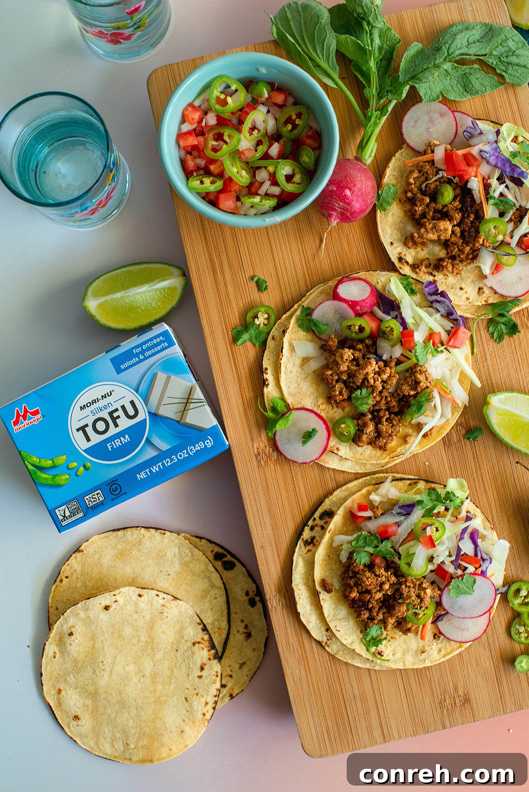 A vibrant spread of tofu street tacos with various fresh toppings ready to be assembled.