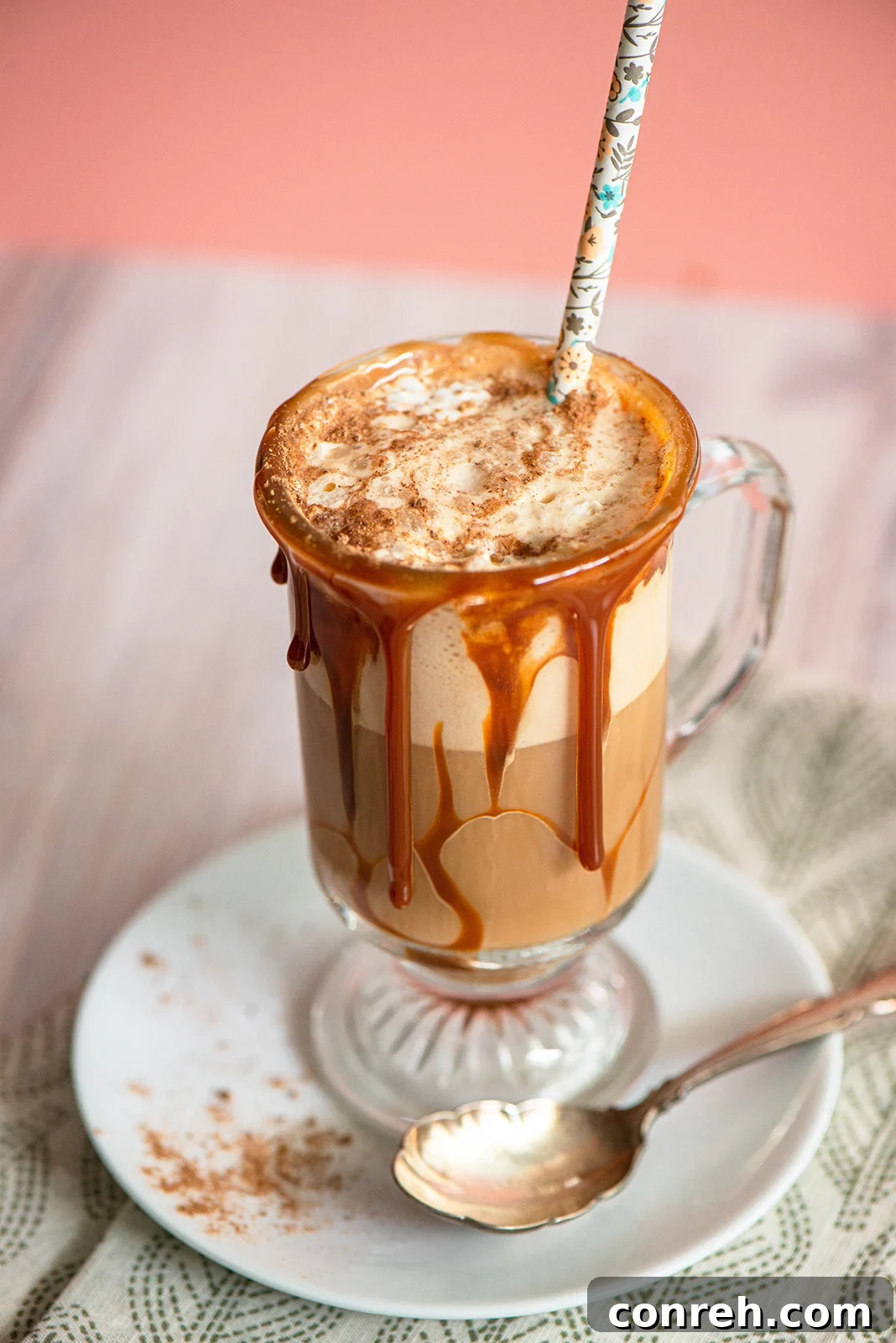 Two glasses of Pumpkin Spice Cajeta Frappe, garnished with nutmeg, ready for serving.