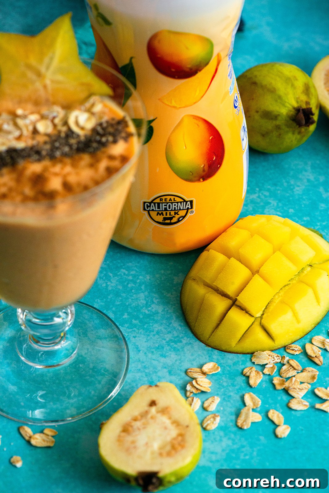 A close-up of a Mango Guava Smoothie in a clear glass, showing the creamy texture and vibrant color, ready to be enjoyed.