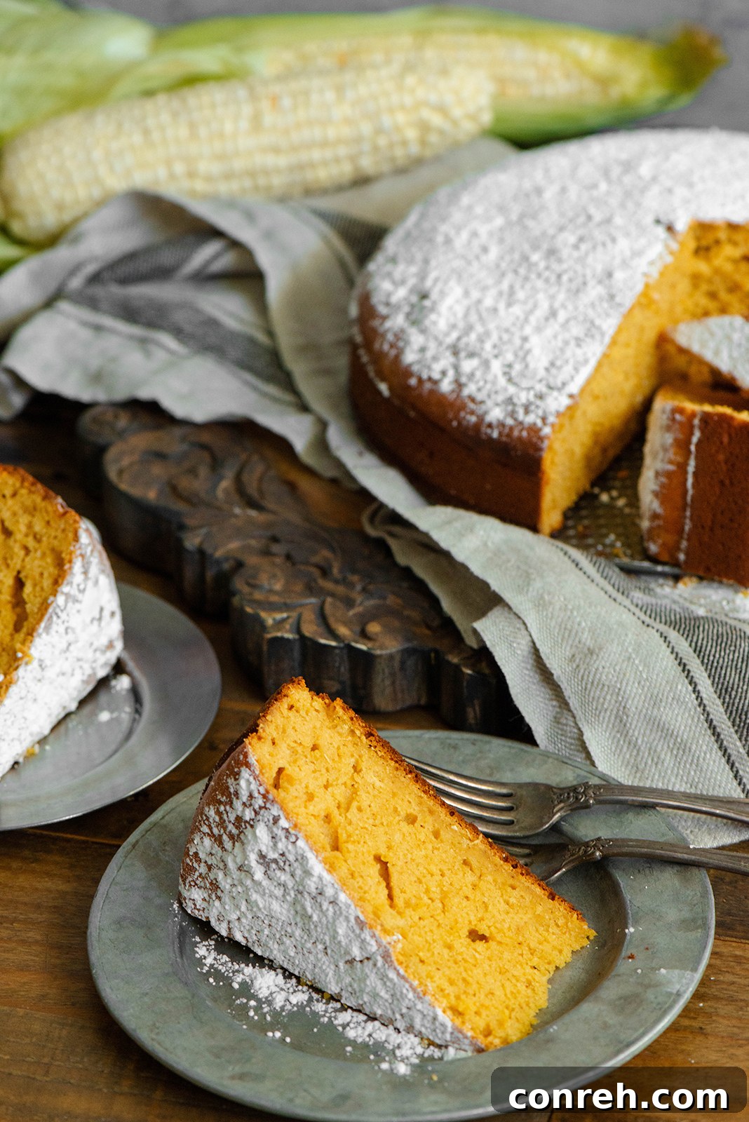 Close-up of a freshly baked Pumpkin Corn Cake, highlighting its golden-brown crust and moist interior, ready to be sliced.