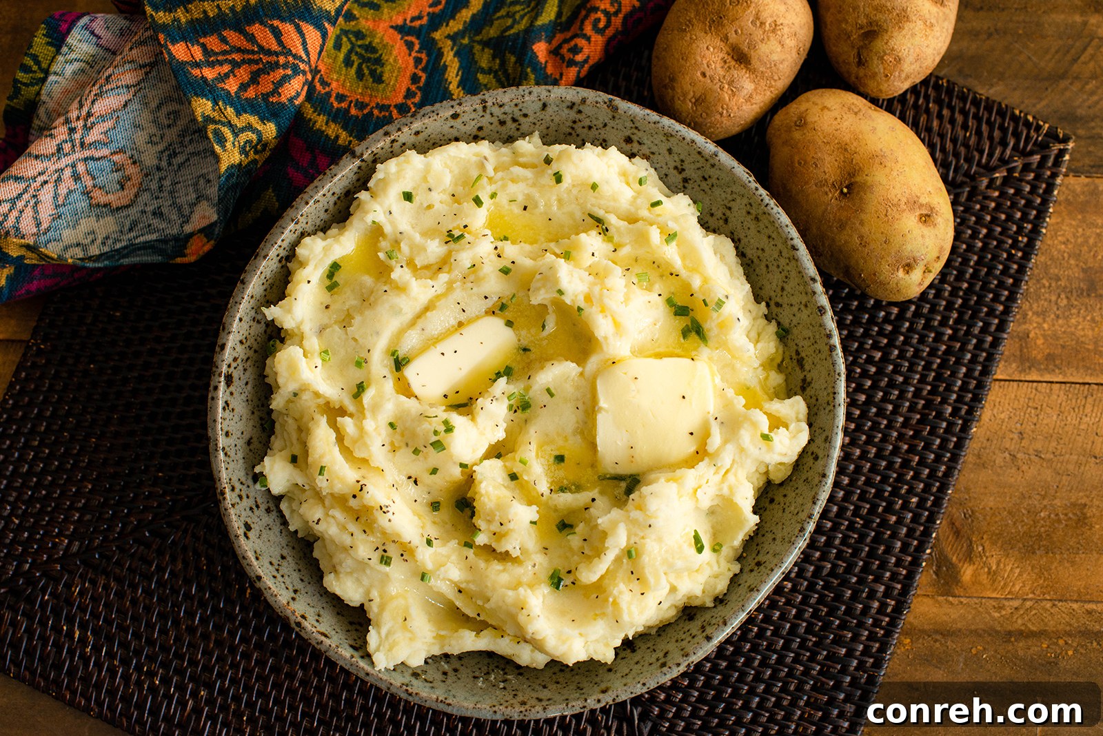 Dreamy Mashed Potatoes 3 A close-up shot of creamy mashed potatoes in a white bowl, garnished with fresh chives, indicating a delicious, ready-to-serve side dish.