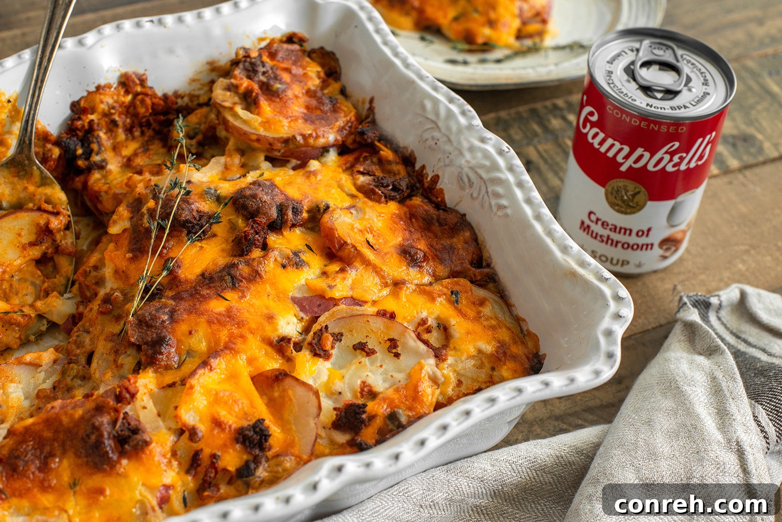 Close-up of golden, bubbling cheesy scalloped potatoes with chorizo.