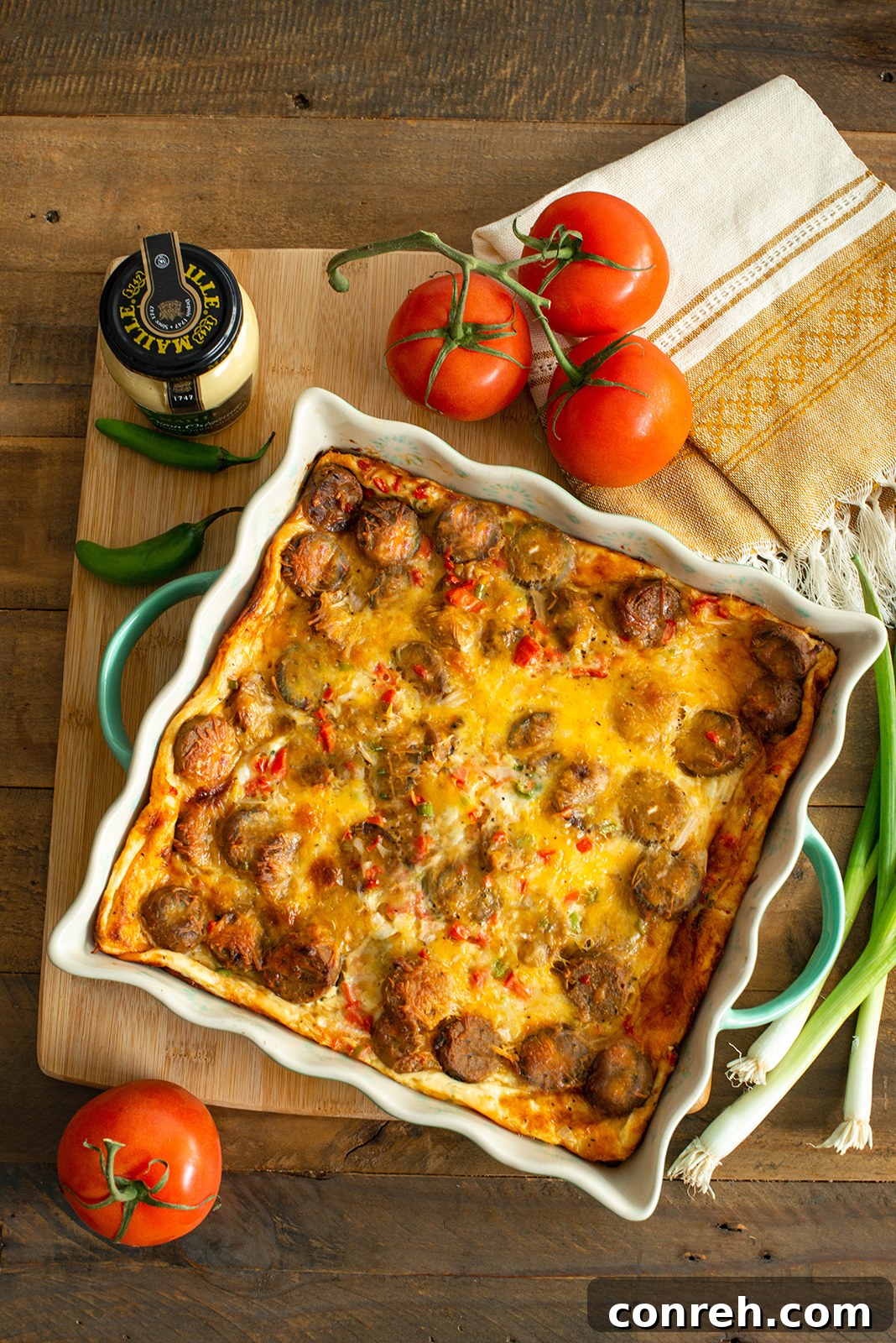 Prepared breakfast casserole in a baking dish, covered and ready for refrigeration