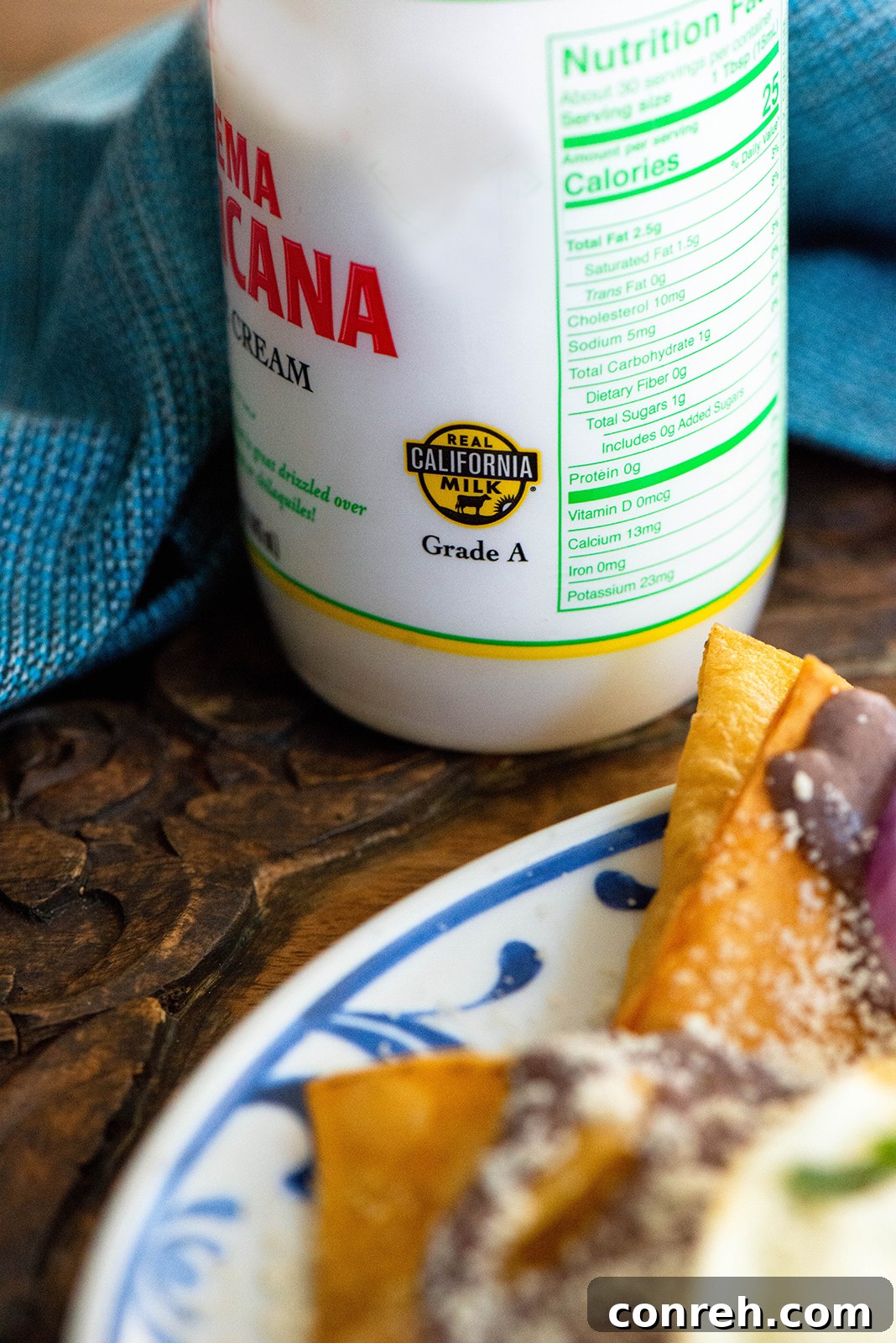 A close-up shot of the Black Bean Chilaquiles ingredients, including fresh epazote leaves and black beans.