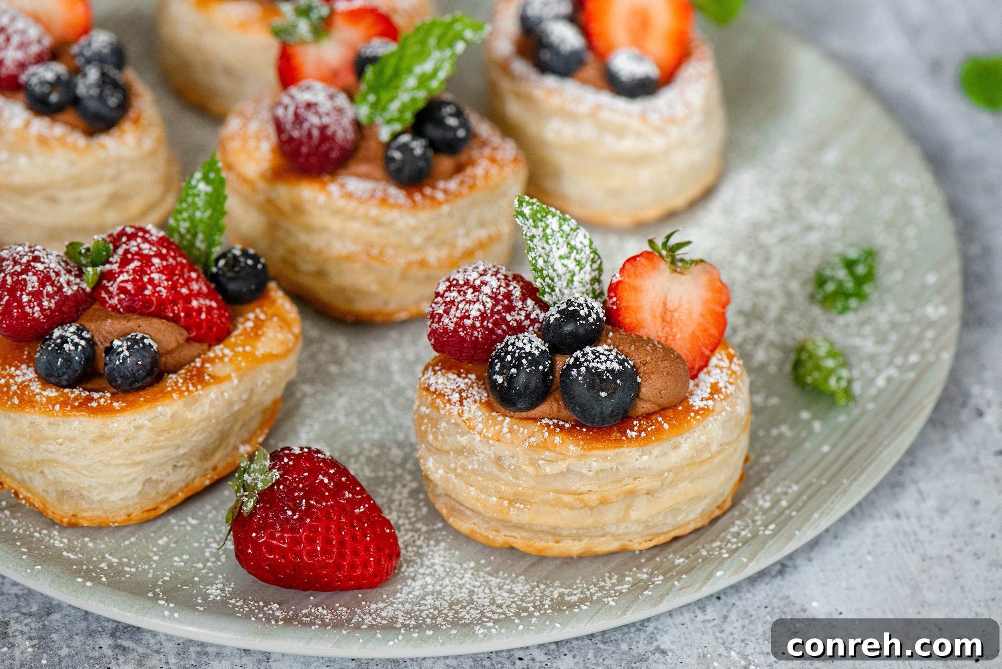 Close-up of a single chocolate cream volovan with raspberries and blueberries.
