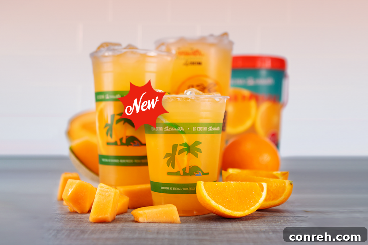 Two vibrant glasses of Cantaloupe and Orange Agua Fresca on a rustic wooden table, perfect for sharing on a sunny day.