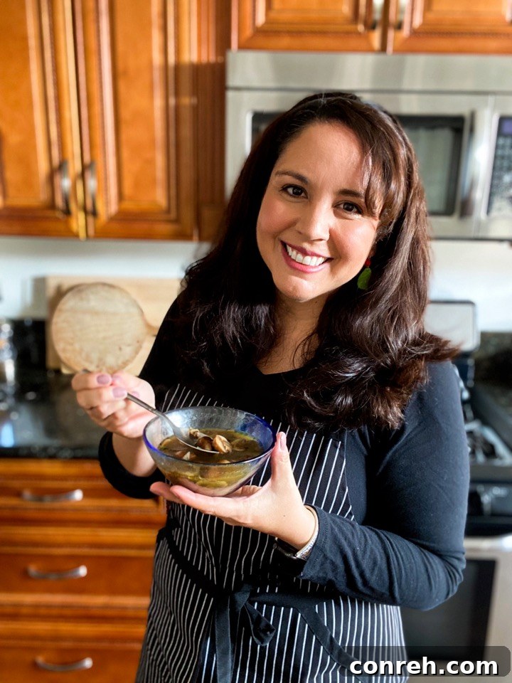 Wild Mushroom Epazote Soup 3 Hand holding a bowl of Mushroom Epazote Soup