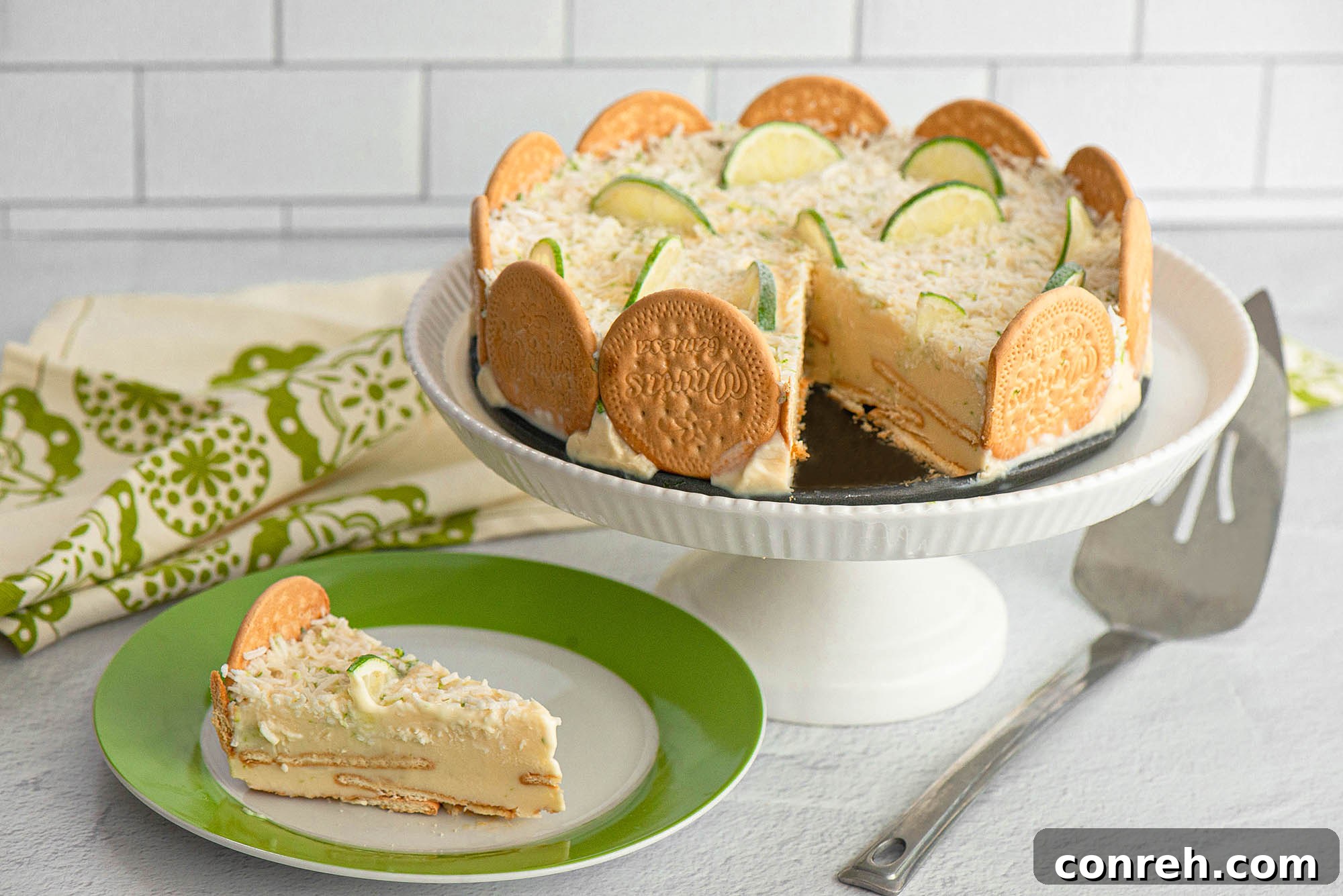 Close-up of a Coconut Lime Carlota slice, showcasing layers of cookies and creamy filling, with tropical garnishes.