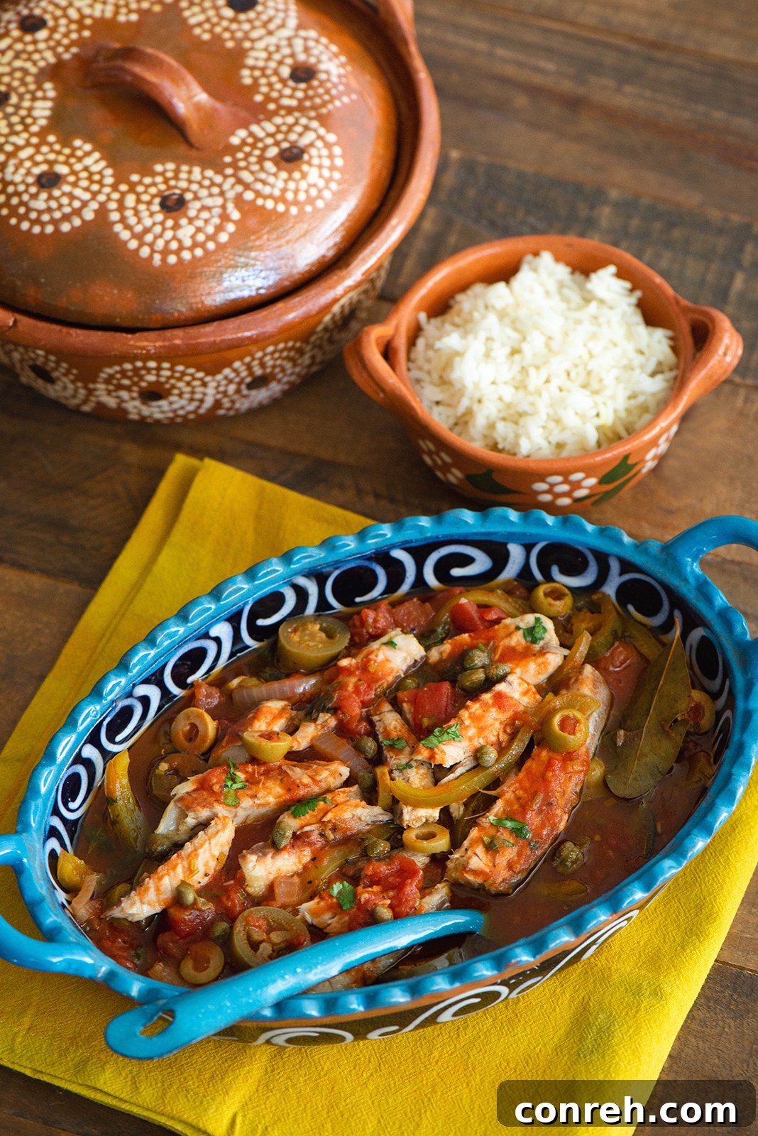 Plated Veracruz Style Mackerel with a side of white rice and fresh herbs