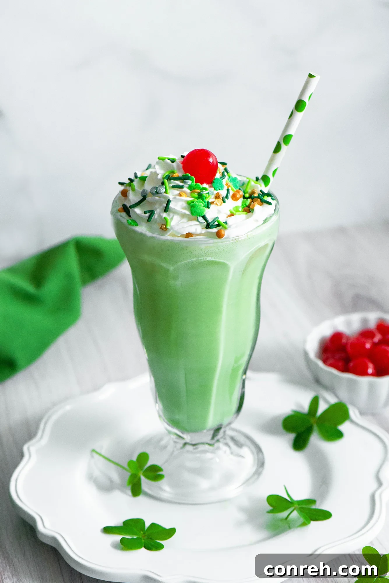 Homemade Shamrock Shake in a glass with whipped cream and a cherry
