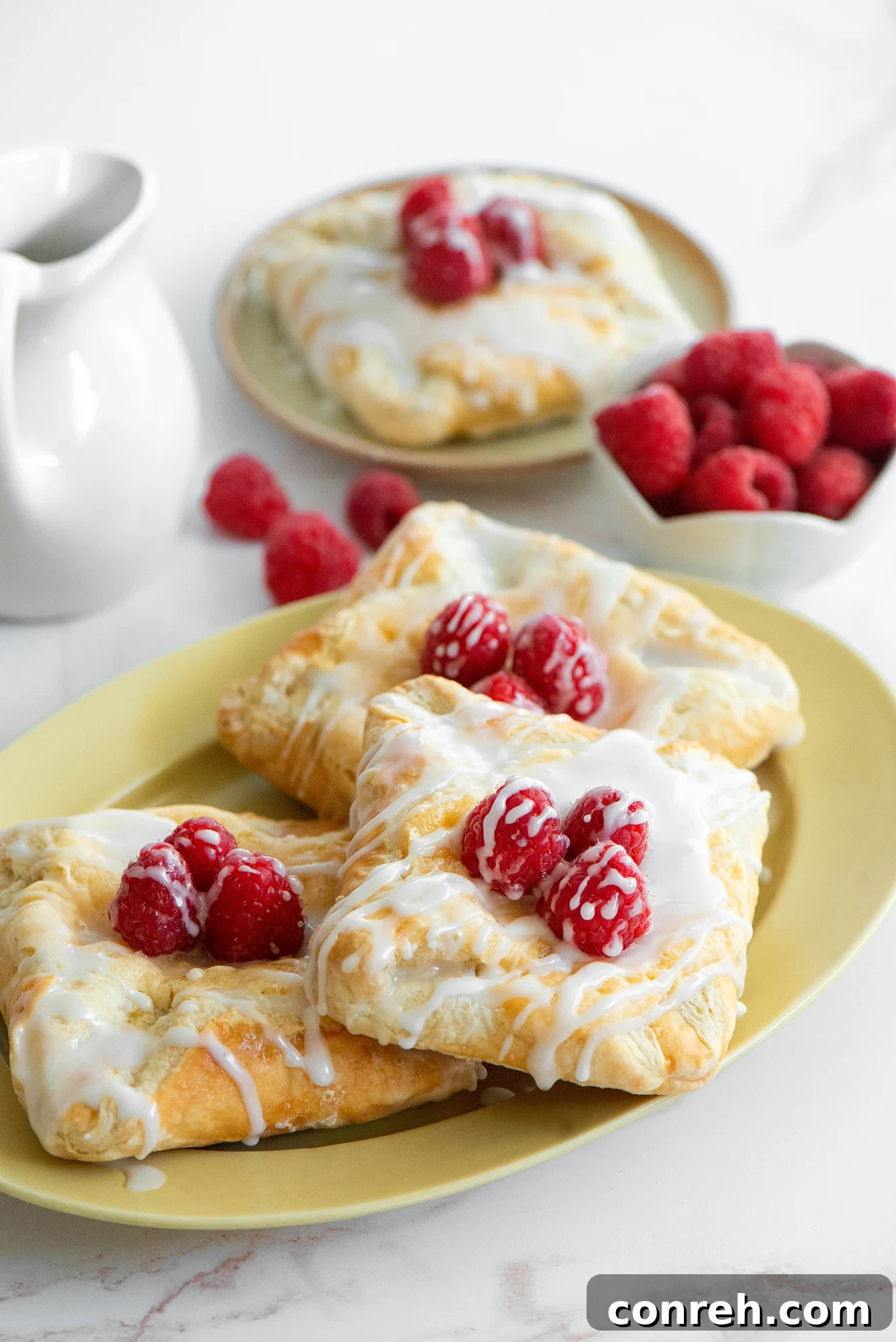 A delicious homemade cheese danish on a plate, ready to be enjoyed with coffee.