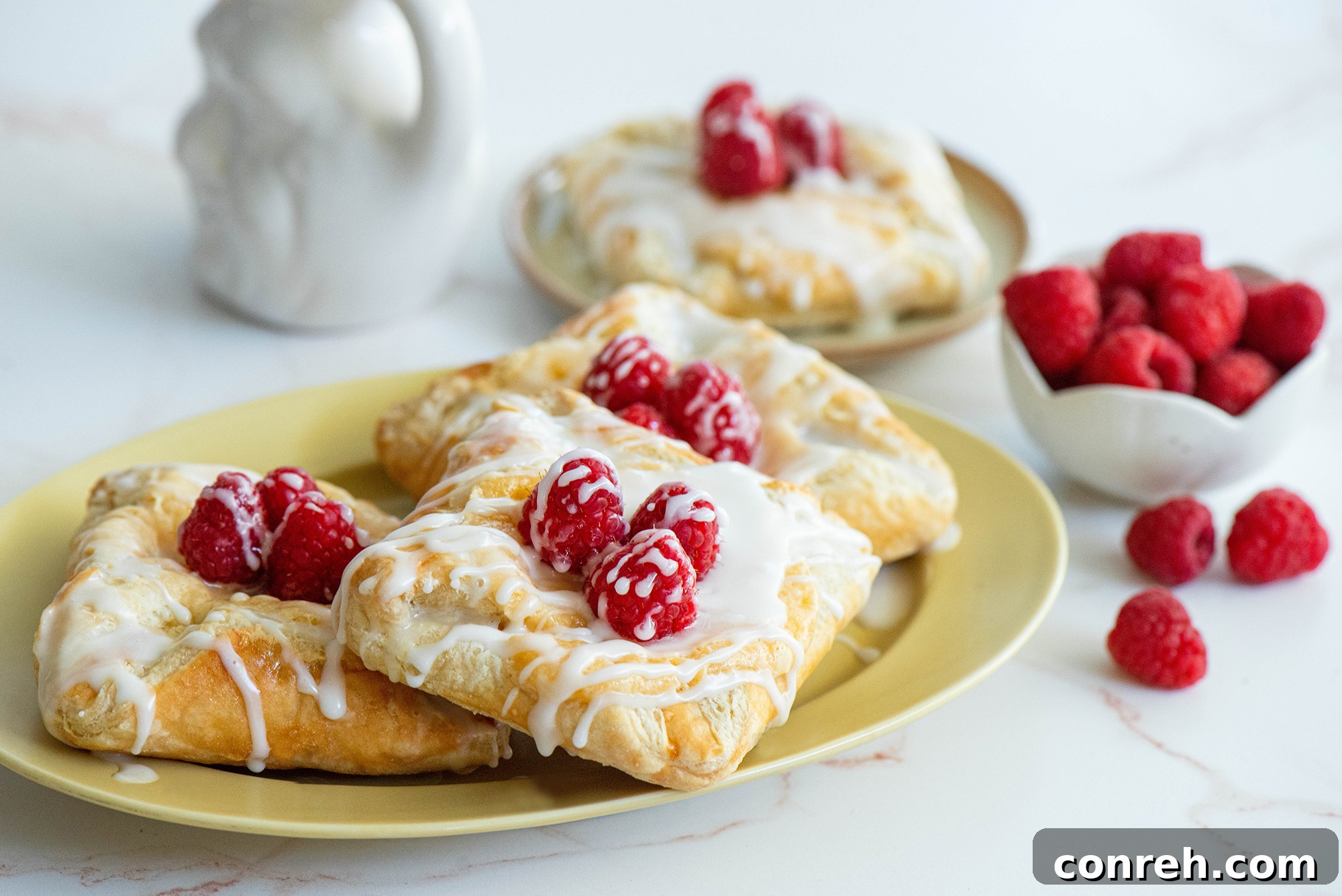 Close-up of golden-brown cheese danishes cooling on a wire rack after baking.