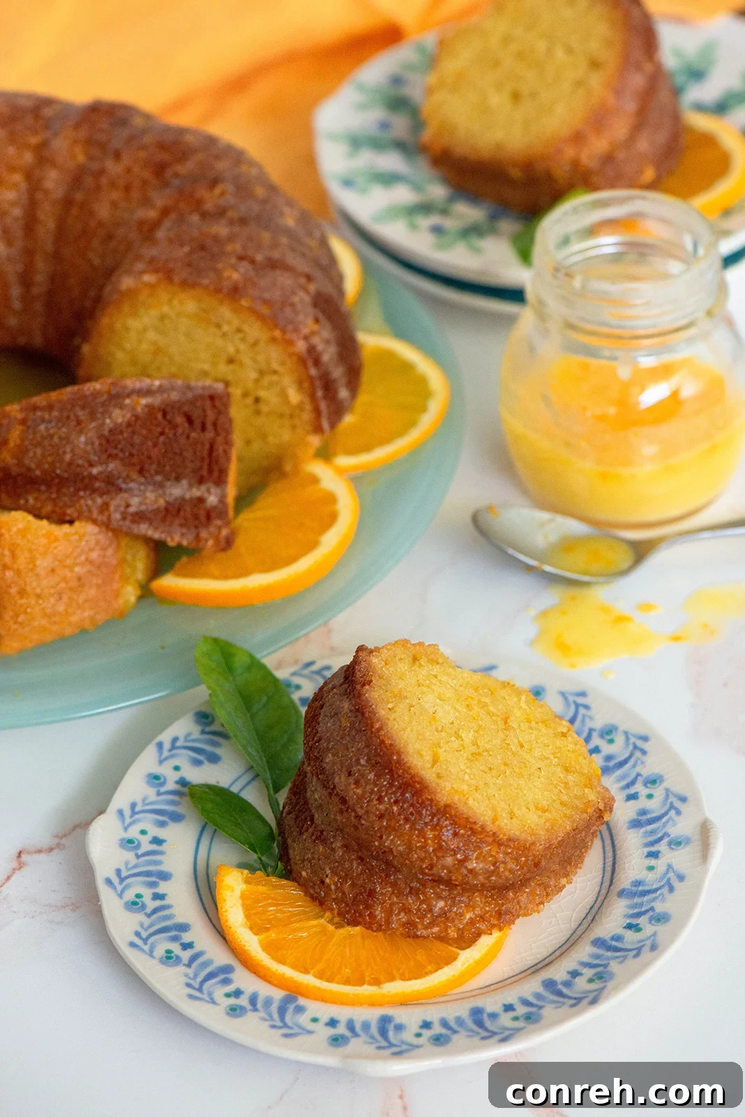Detailed shot of an orange cake slice, showing its moist crumb and glaze.
