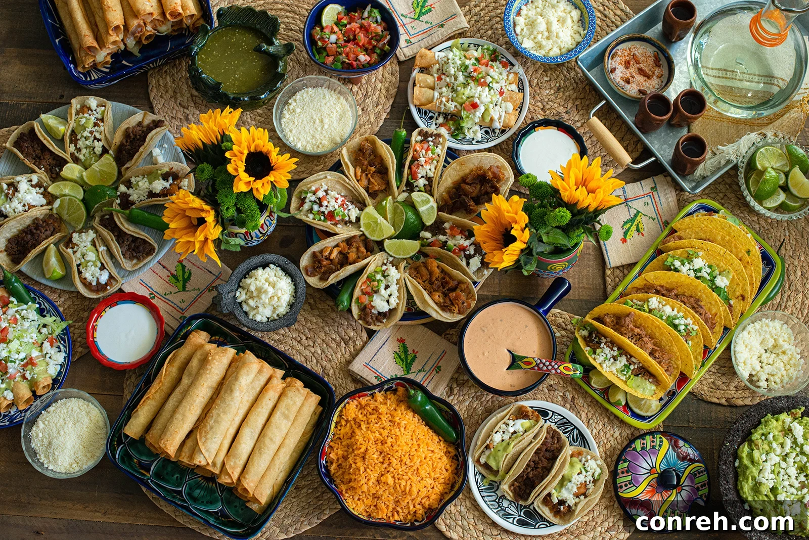 A vibrant taco table spread with various toppings and dishes, perfect for a festive gathering.