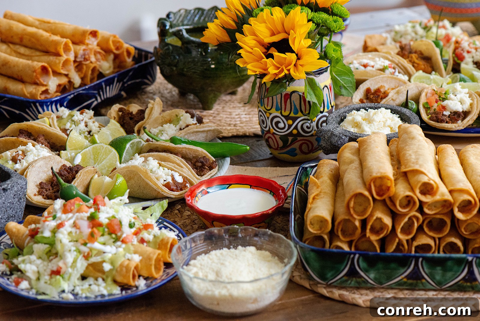 An overhead shot of a beautifully arranged taco table with multiple serving bowls.