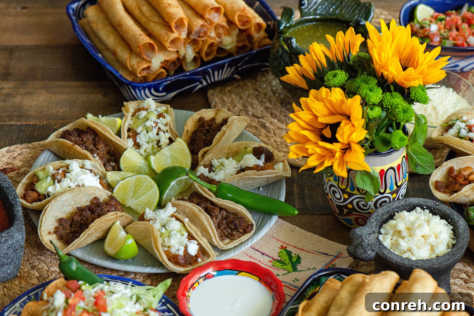 A close-up of a platter of fresh, colorful vegetables and salsas for a taco bar.