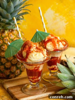 Homemade Piñanada ice cream topped with chamoy and Tajin