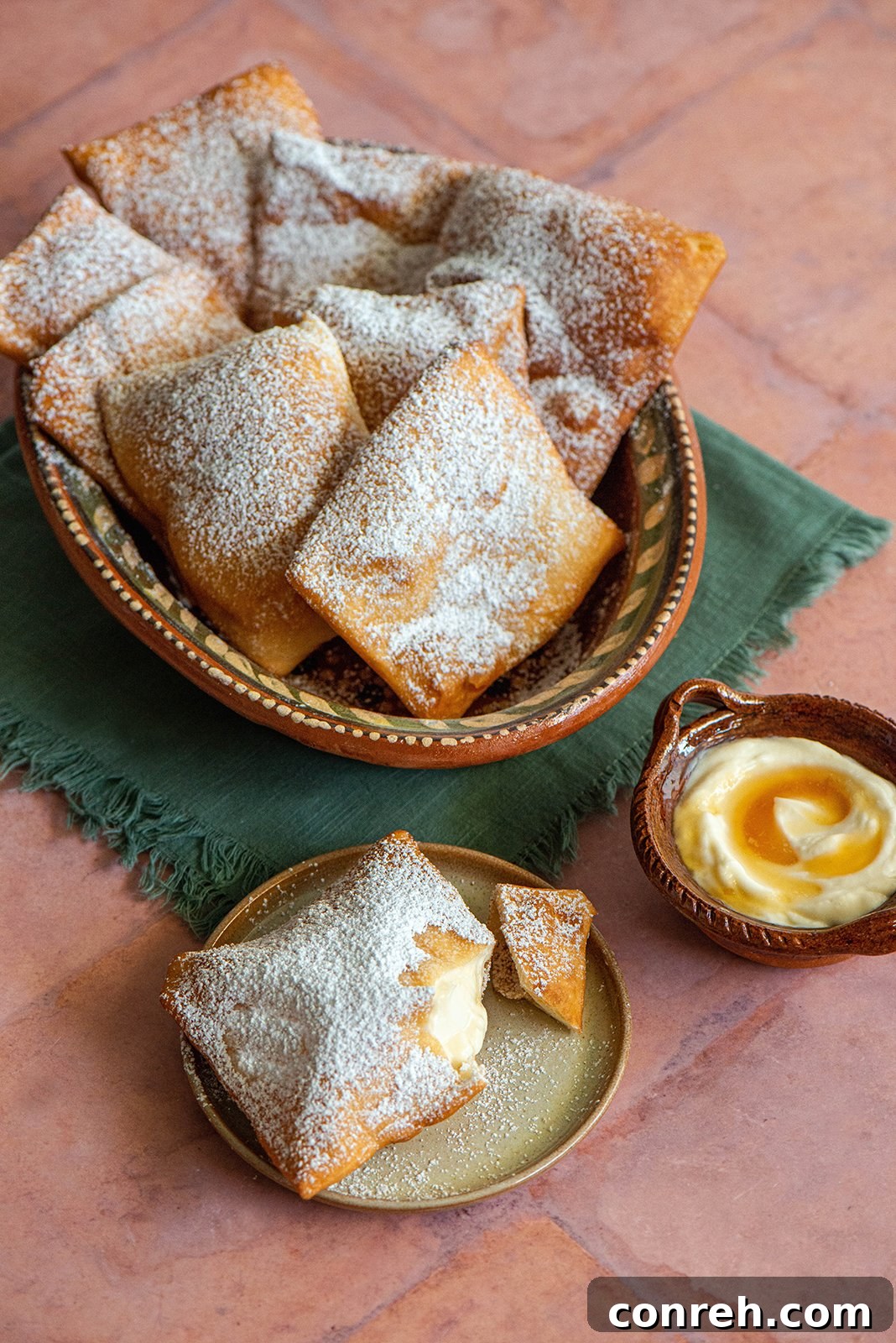 A plate of golden sopaipillas drizzled with honey, ready to be enjoyed as a New Mexican treat.