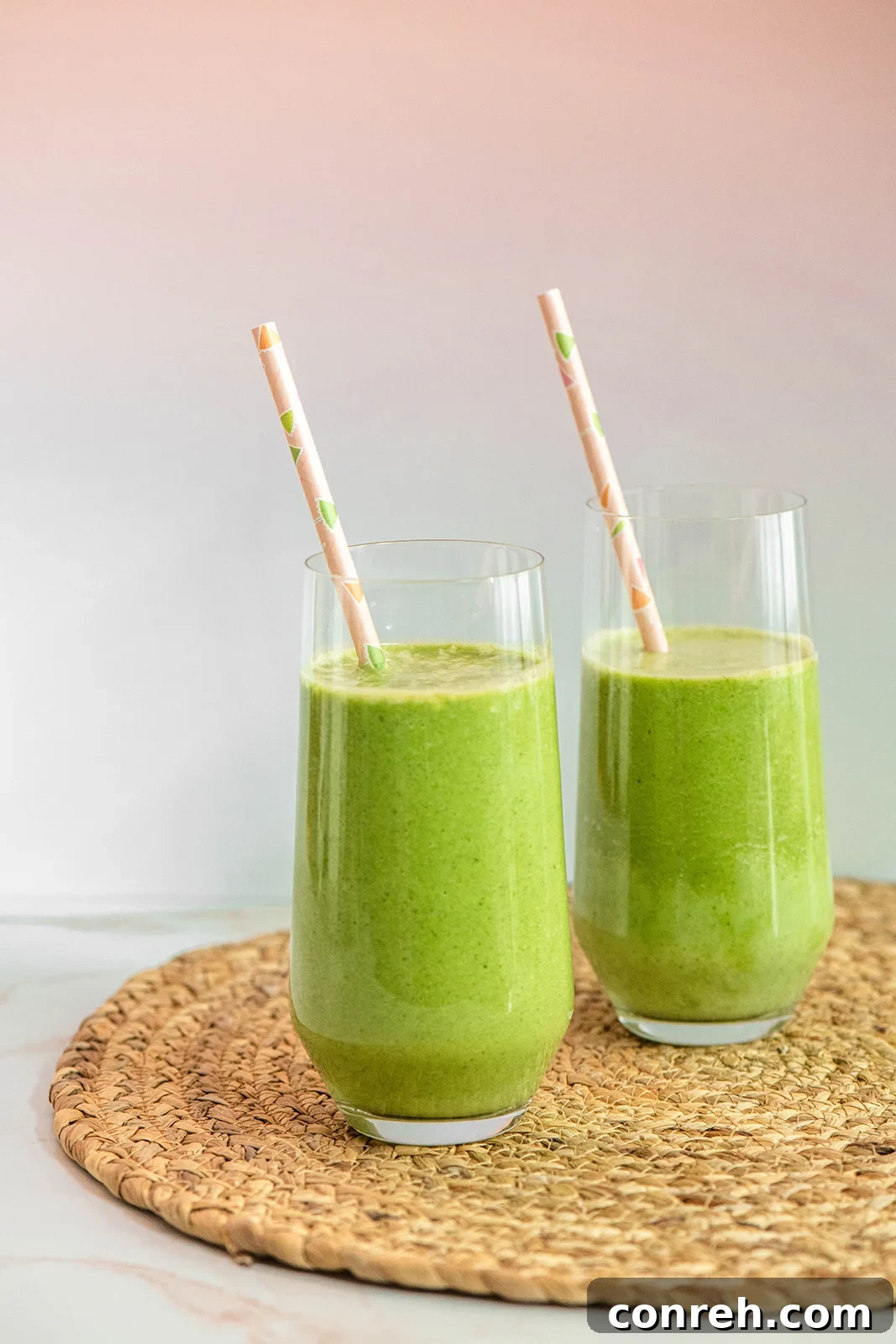 Green Goddess Smoothie in a glass with straw