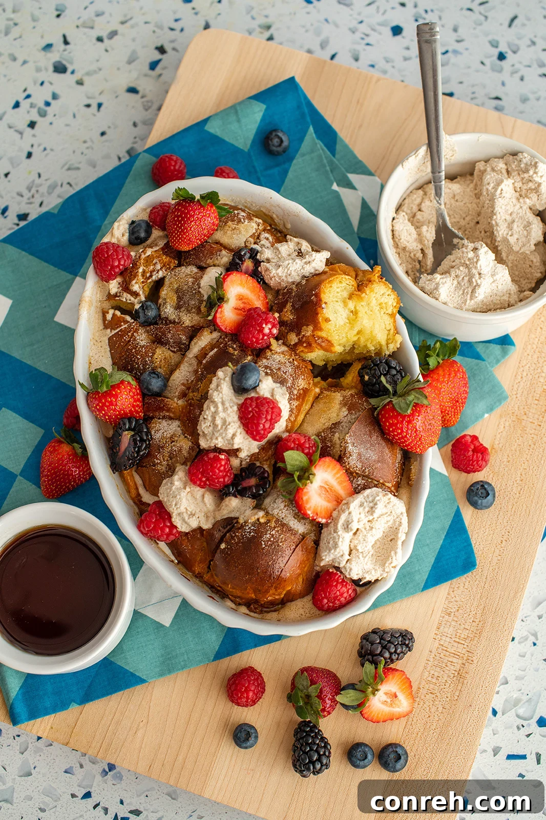 Delicious Pull Apart French Toast with Cinnamon Whipped Cream and fresh berries, ready to be served family-style for an impressive brunch.