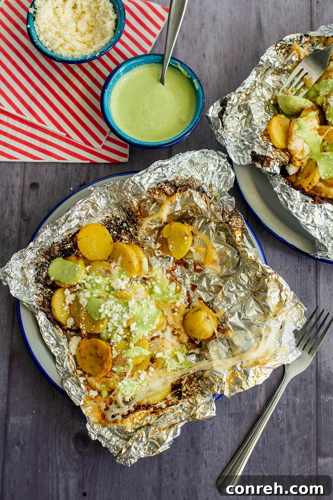 Delicious Campfire Potatoes with Jalapeño Crema in foil packets, ready for grilling