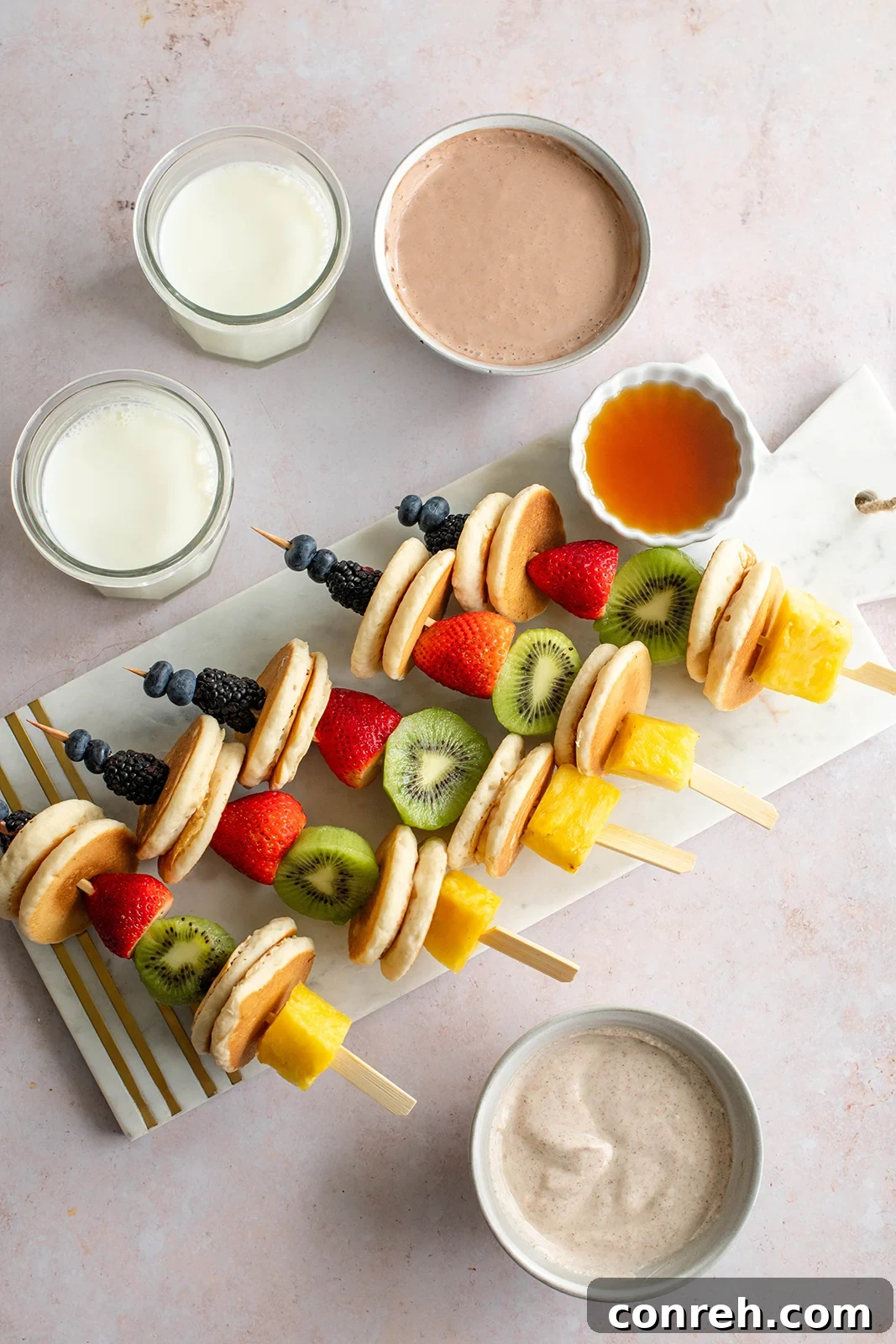 Close-up of Pancake Fruit Skewers with various fruits and a creamy dip