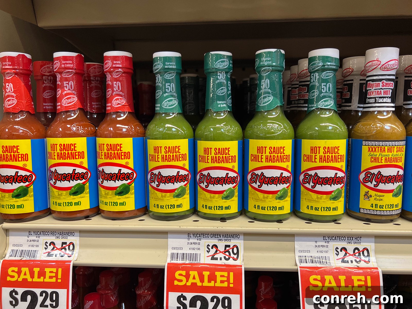 Bottles of El Yucateco hot sauce displayed at a store