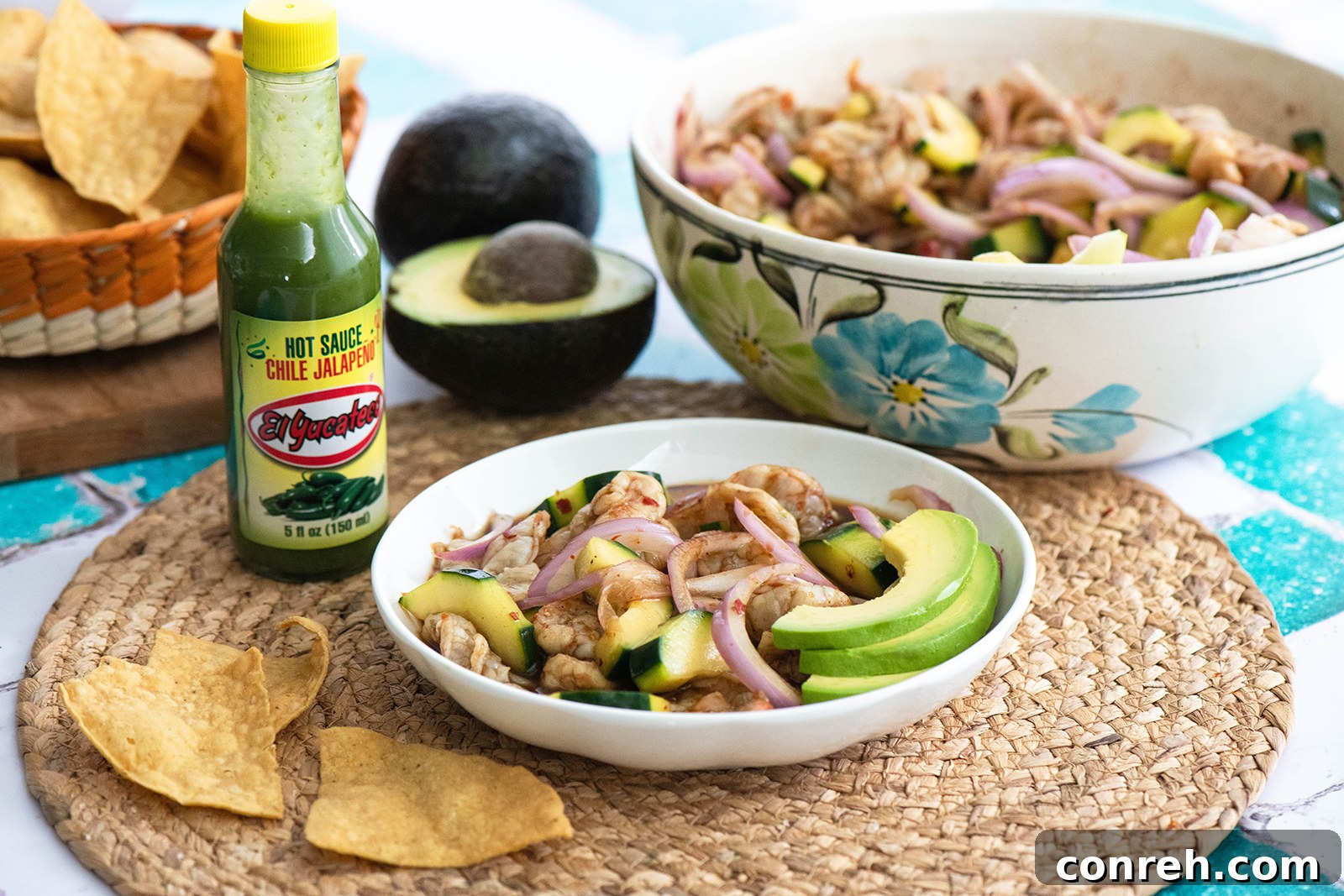Aguachile Negro ready to be served with avocado and chips