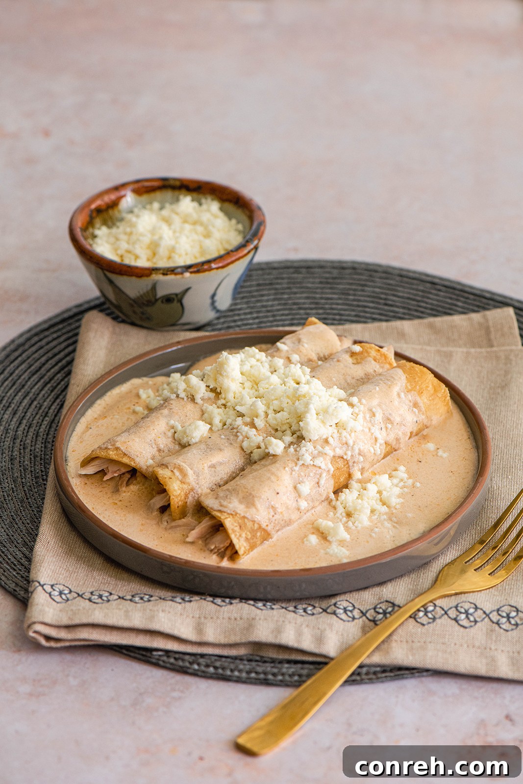Delicious Enjococadas with creamy jocoque sauce, shredded chicken, and crumbled queso fresco on corn tortillas, garnished with fresh cilantro.