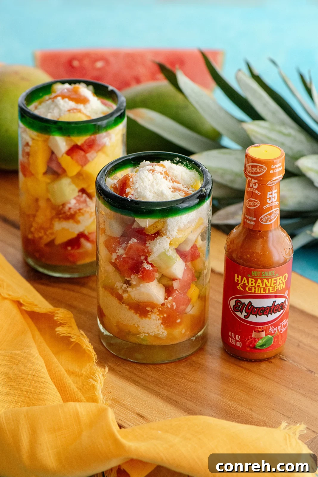 Morelia's Refreshing Gazpacho 3 Close-up of a second glass of Gazpacho Moreliano, showing the delicious layers of fruit, cheese, and hot sauce, inviting a taste.