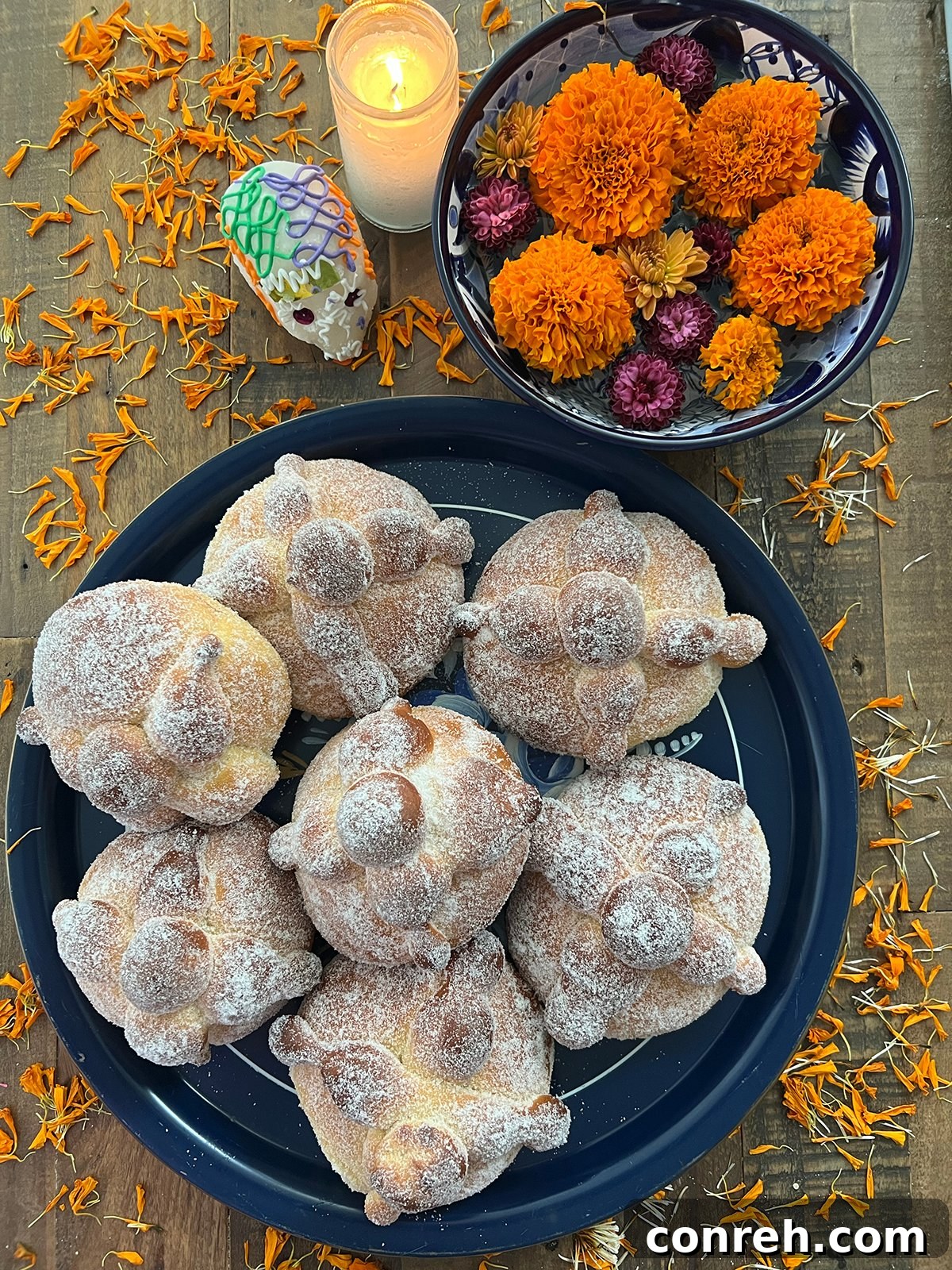 Freshly baked Pan de Muerto, a traditional Mexican bread, fluffy and covered in sugar, perfect for Dia de Muertos festivities